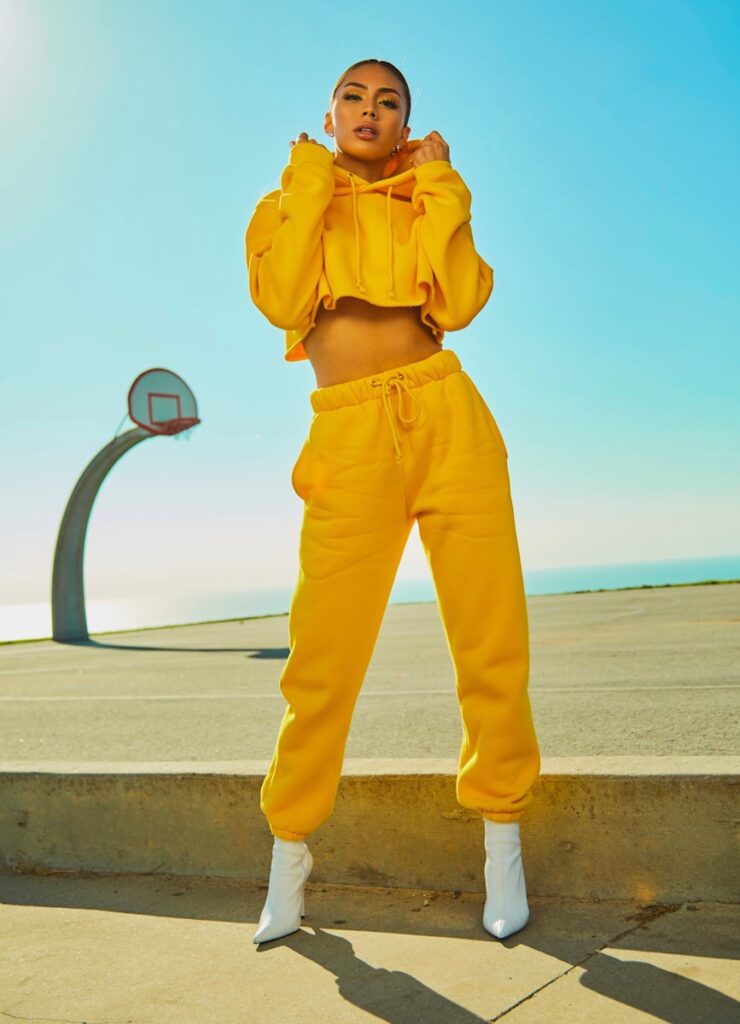 woman in yellow tracksuit standing on basketball court side ai generated